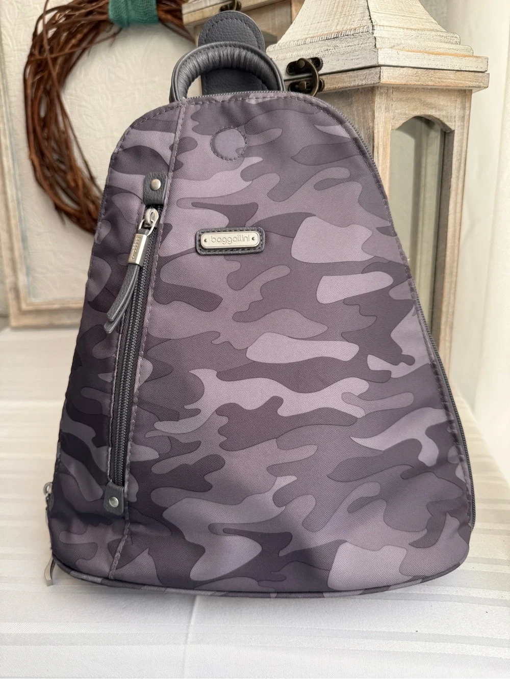 Baggallini MM Metro Backpack in a Dark Gray Camo print.